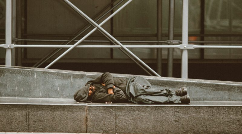 man lying on concrete stairs