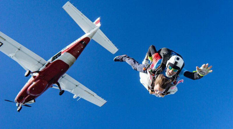 white and red airplane in mid air during daytime