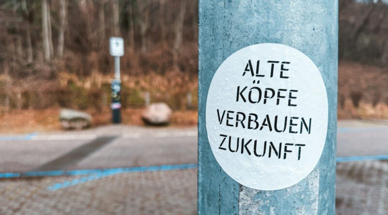 A blue pole with a white sticker on it