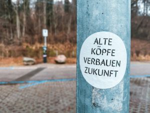 A blue pole with a white sticker on it