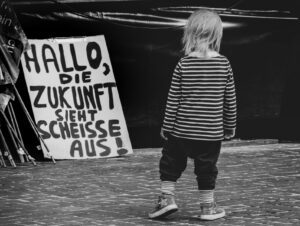 A little girl standing in front of a sign