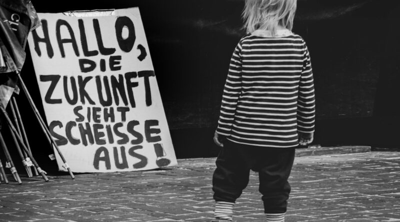 A little girl standing in front of a sign