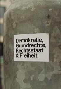 a sticker on a pole in front of a building